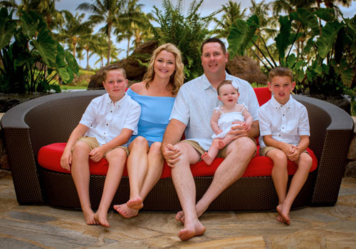 Nathan, Stefanie and kids sitting on patio sofa